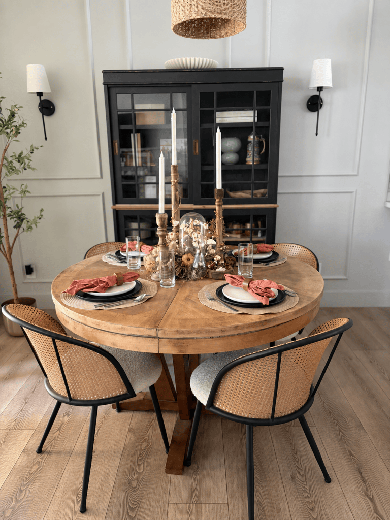 Fall dining table with woodland centerpiece, candlesticks and pumpkin place settings