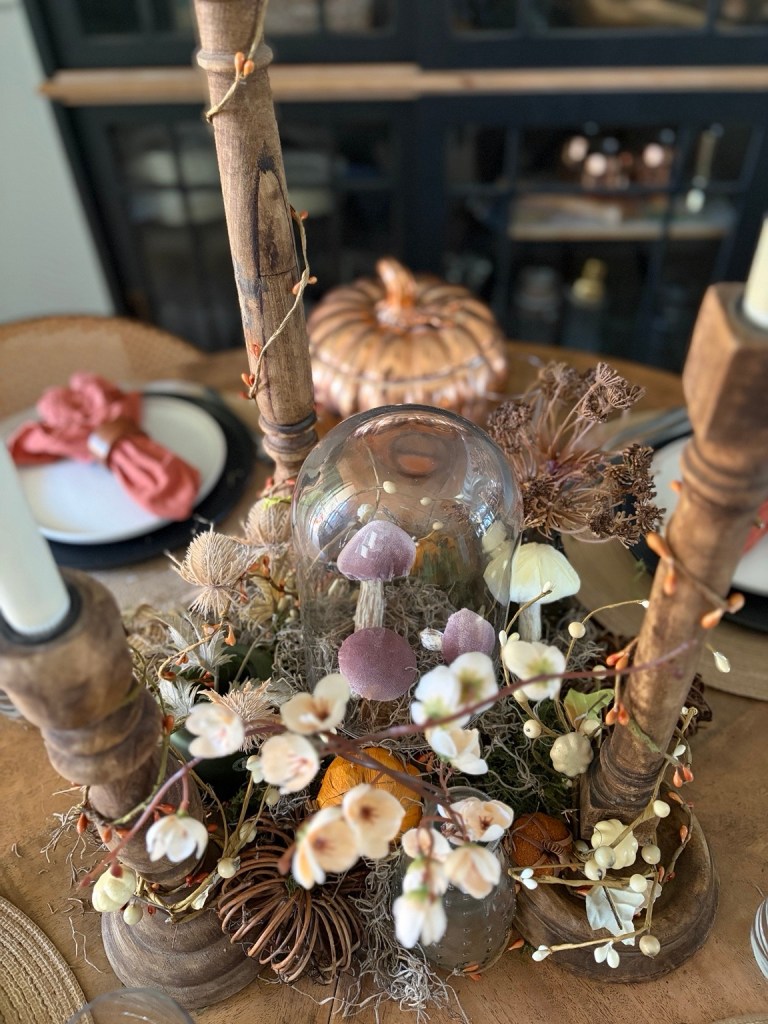 Woodland fall centerpiece with mushrooms, moss, branches and rustic candlesticks