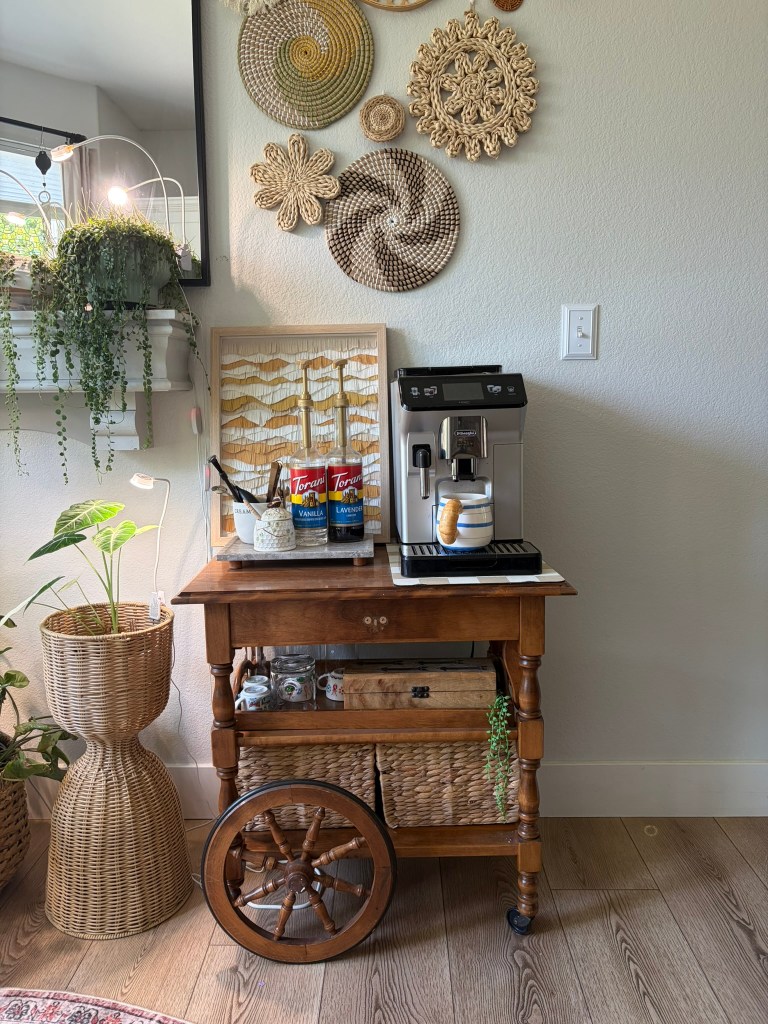 Middle shelf of vintage tea cart styled with mugs and plant