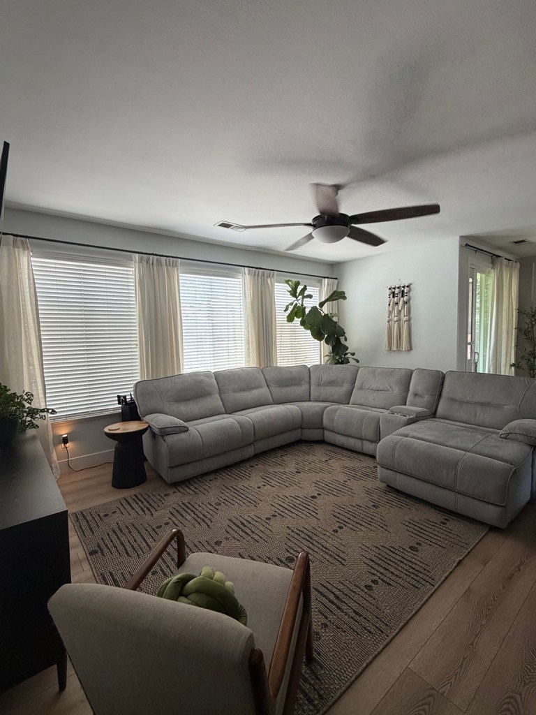 Finished modern organic living room with a World Market rug and light neutral walls
